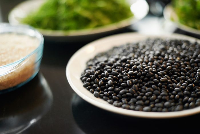 bowls of black beans, brown rice, and greens