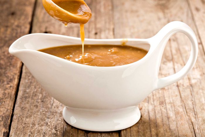 white gravy boat filled with brown gravy