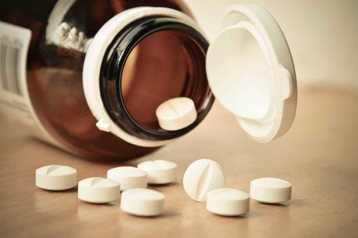 Bottle of diuretics spilling pills onto the table.