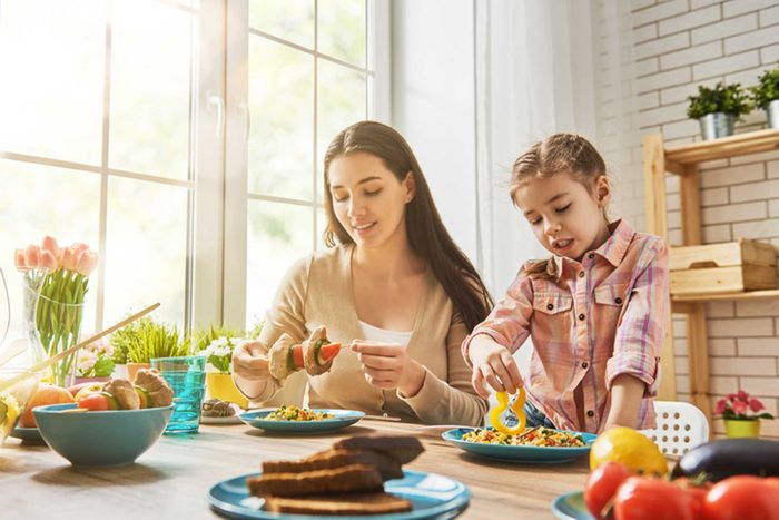 Woman and young girl preparing food