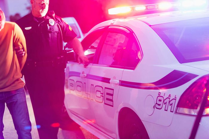 Police officer escorting person to his cruiser