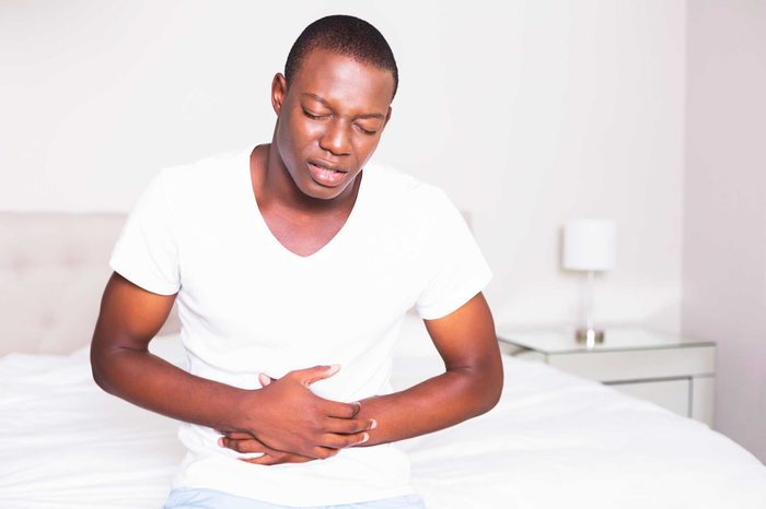 Man clutching aching belly