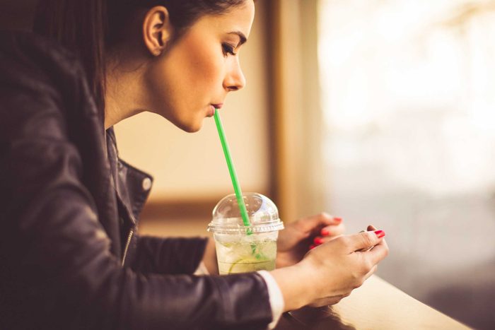 woman sipping from straw