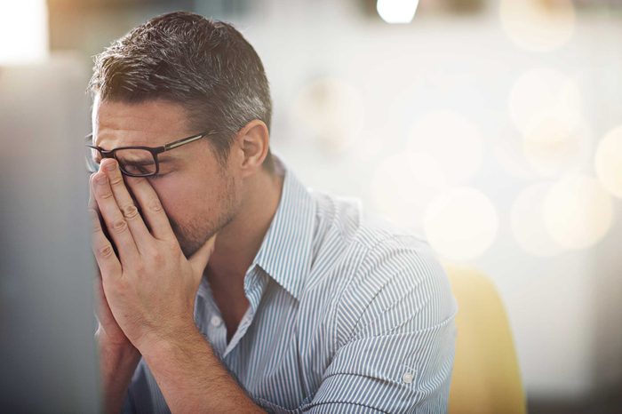 Exasperated man with his hands on his face