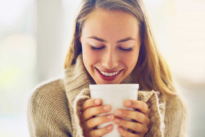 smiling woman with white mug