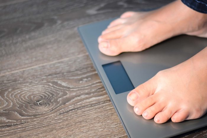 man's feet standing on a scale