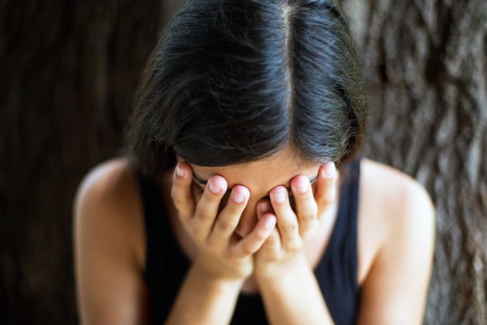 woman resting her face in hands