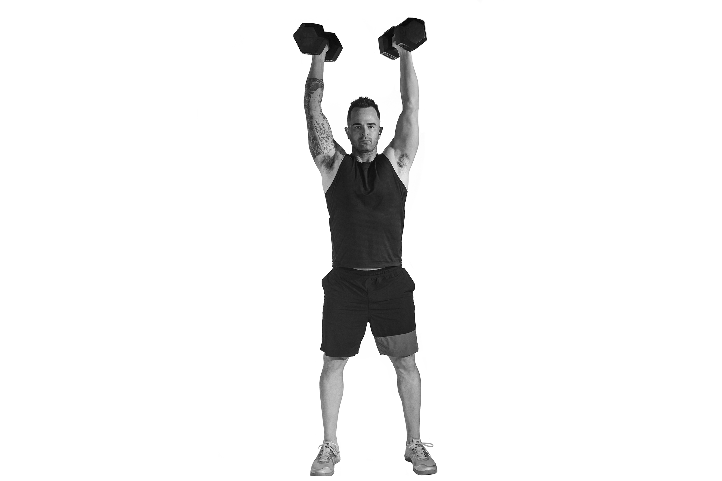 Man doing dumbbell thruster. 