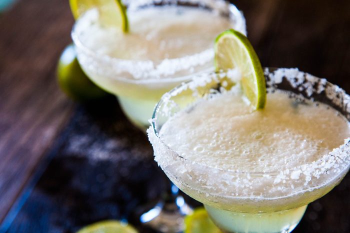 Two glasses of tequila with lime slices. 
