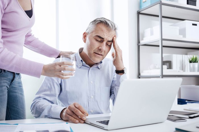man at work holding his head
