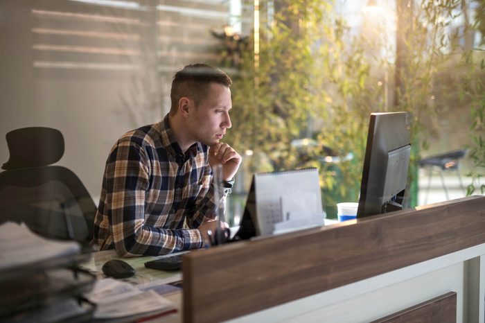 Man looking at his computer in an office