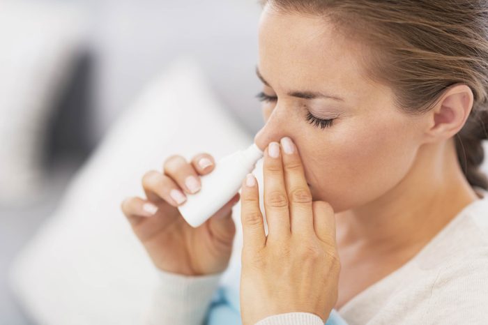 woman using a nasal inhaler