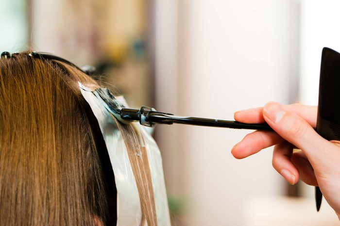 woman getting highlights in her hair