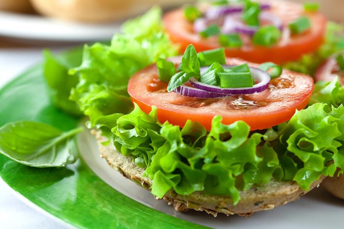 stacked lettuce, onion, and tomato