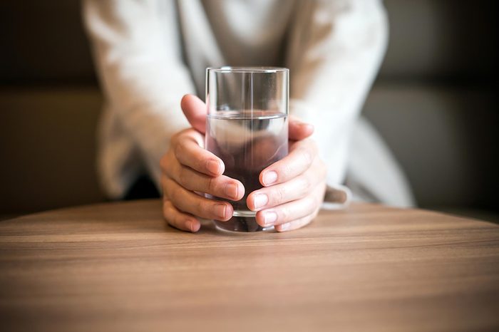 a person holding a glass of water