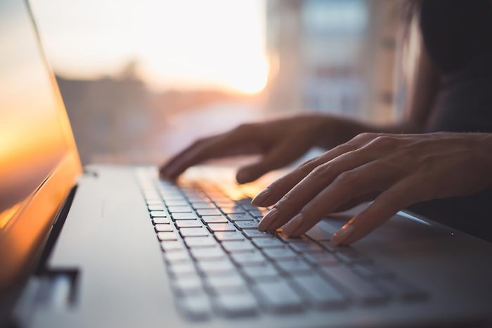 hands typing on computer