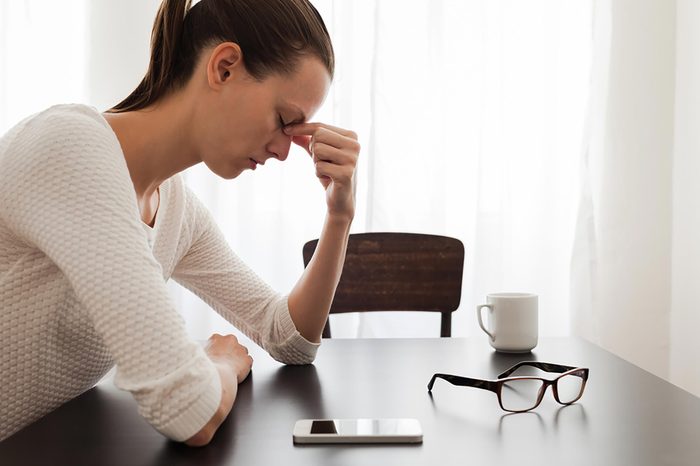 stressed woman sitting at table