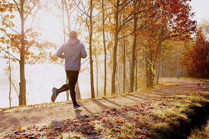 man running through the woods