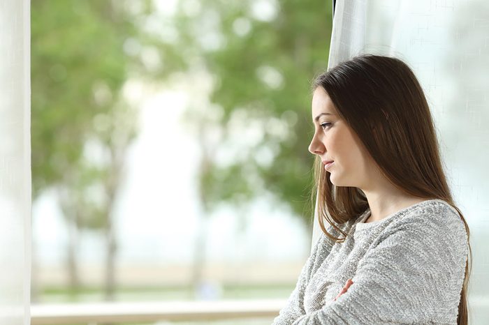 woman staring out of the window