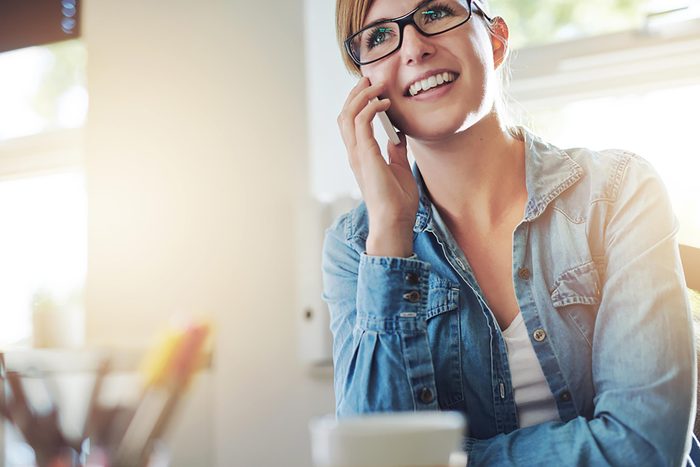 woman in glasses talking on phone