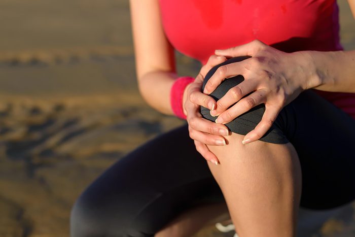 woman holding knee