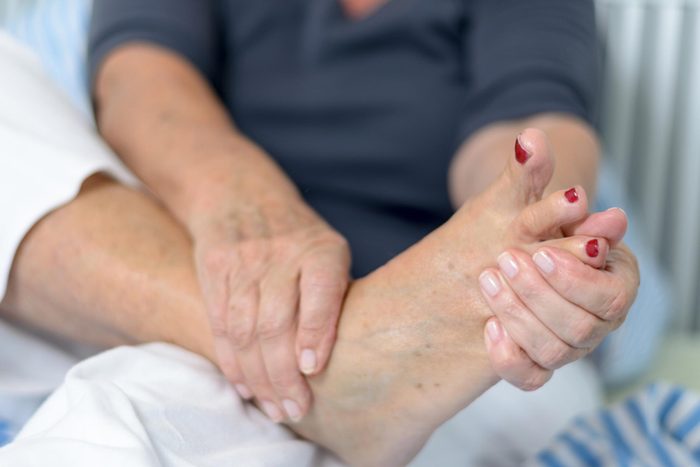 hands holding foot