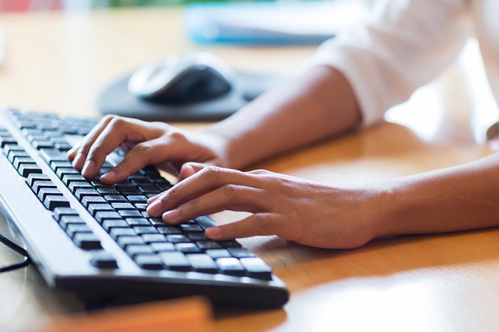 hands typing on a keyboard