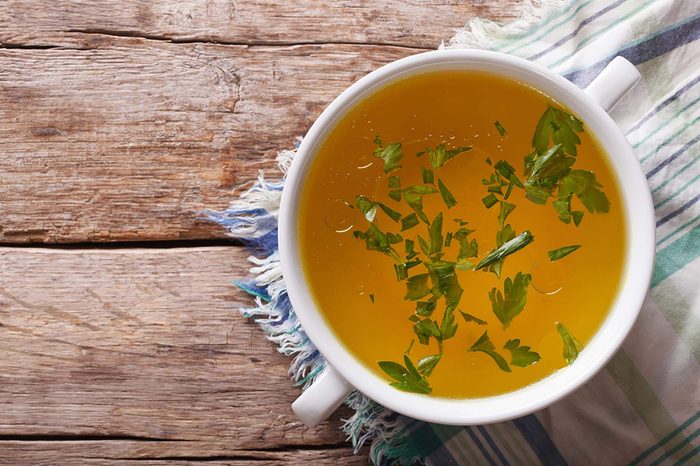 Bowl of soup with chopped green onions.