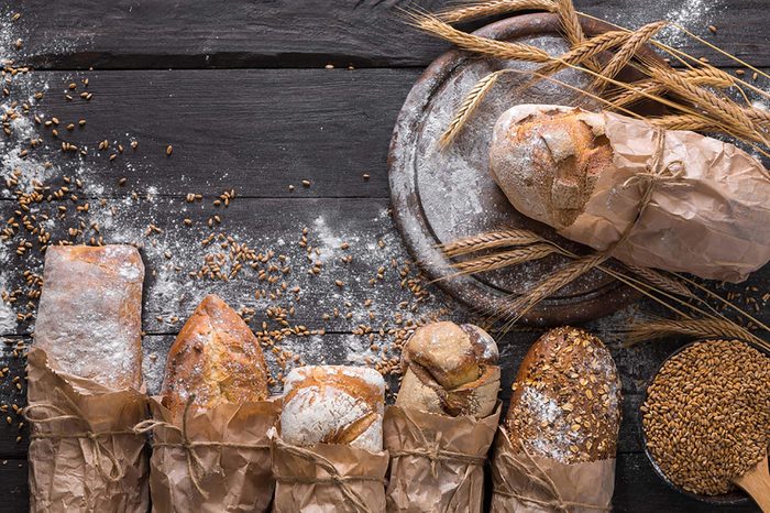 Rolls of bread on a wooden table.