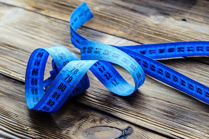 measuring-tape on wooden surface