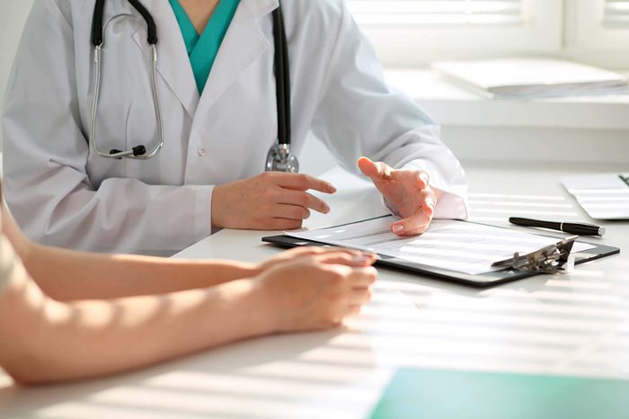 Doctor speaking with a patient at the doctor's office.