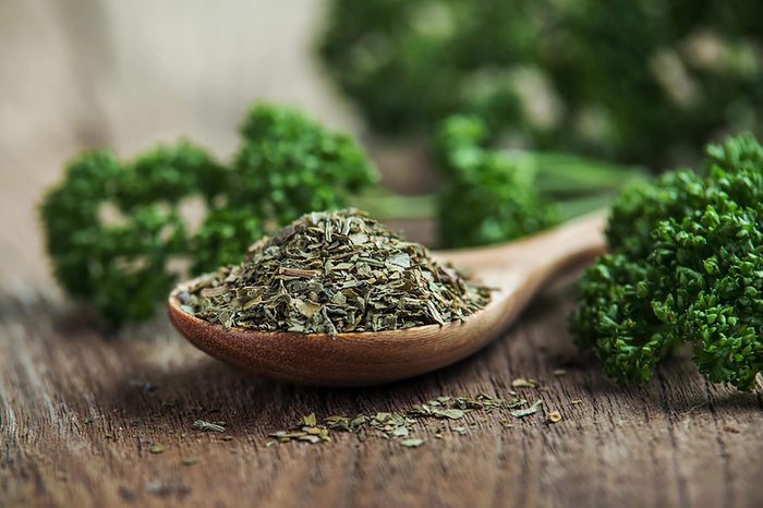 Parsley in wooden spoon