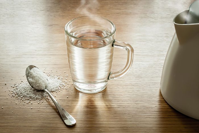 glass with spoon of epson salt for laxative