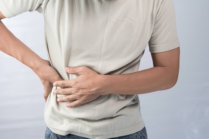 person with hand on abdomen