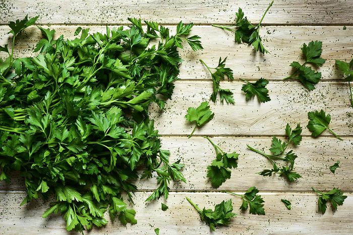 Parsley on wooden cutting board