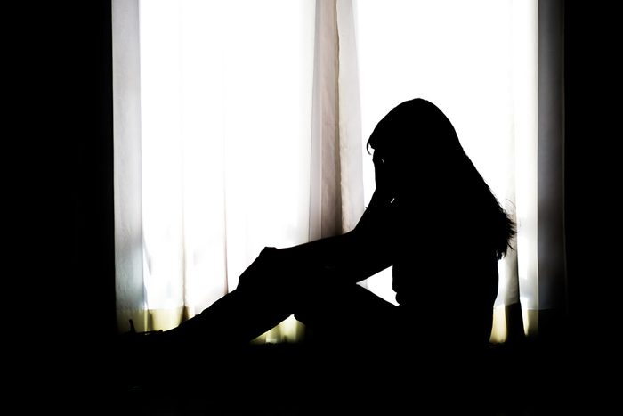 silhouette of a woman in a window