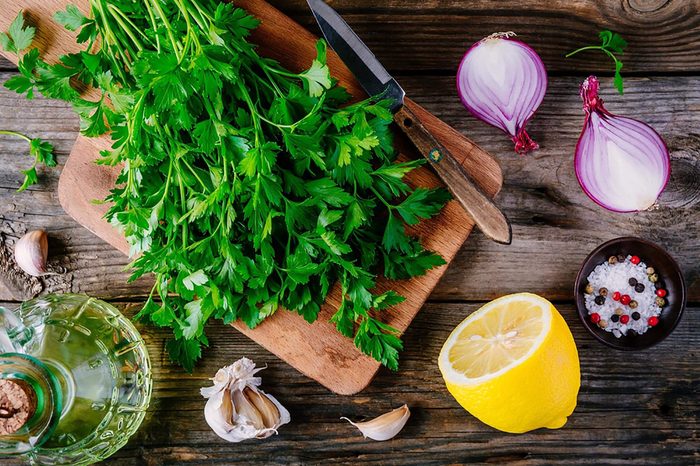Parsley, lemon, onion on cutting board