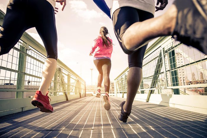 People running on a pedestrian bridge