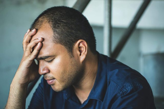 man holding his head