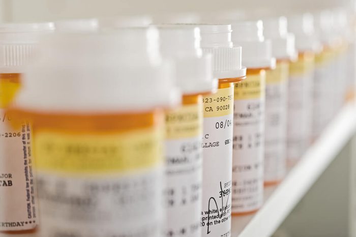 Bottles of pills arranged on shelf at drugstore
