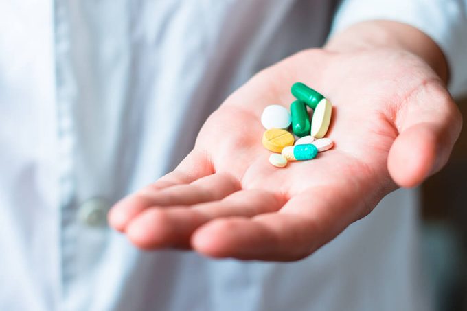 A handful of pills and capsules.