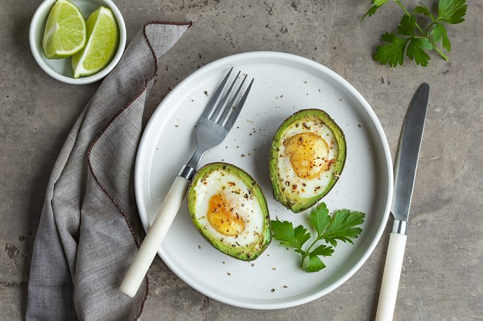 Two eggs baked into avocado halves.