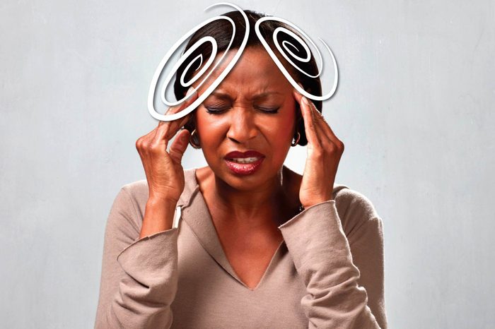 black woman pressing against her temples