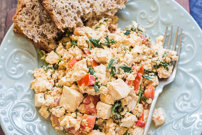 Tofu scrambled eggs and a side of multigrain bread.
