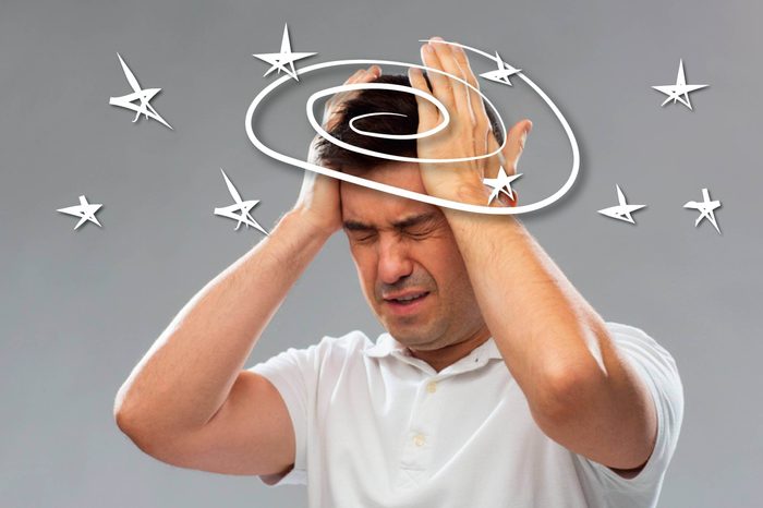man wincing with vertigo