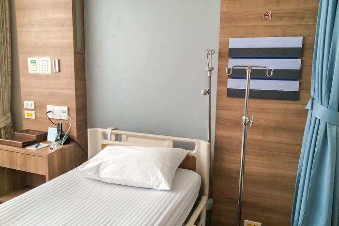 Empty hospital bed with medical equipment.