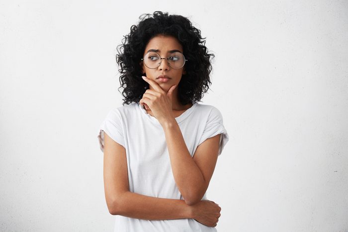 woman with doubtful expression, looking away