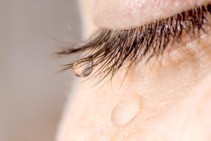 A tear on eyelashes and cheek.