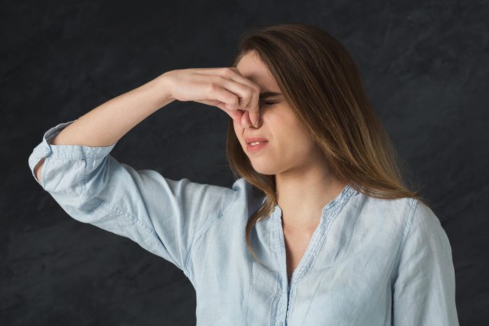 woman pinching her nose