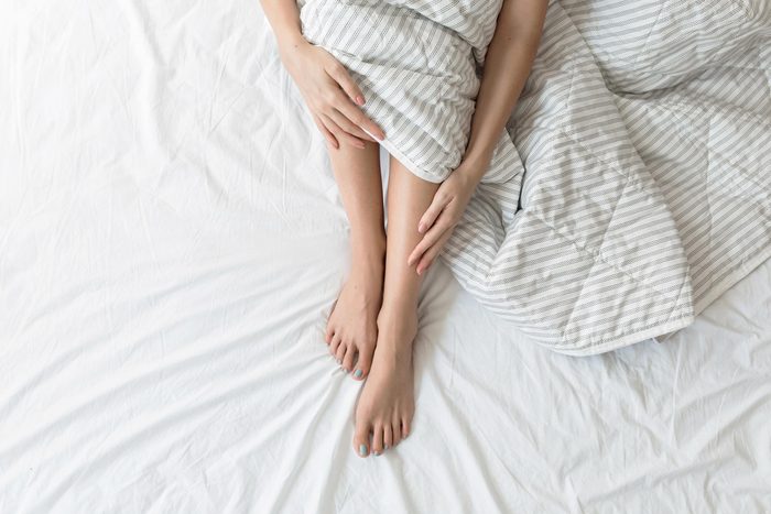 feet legs sheets bed